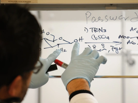 A person wearing rubber gloves working in a lab