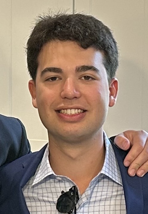 A young person dressed professionally smiling