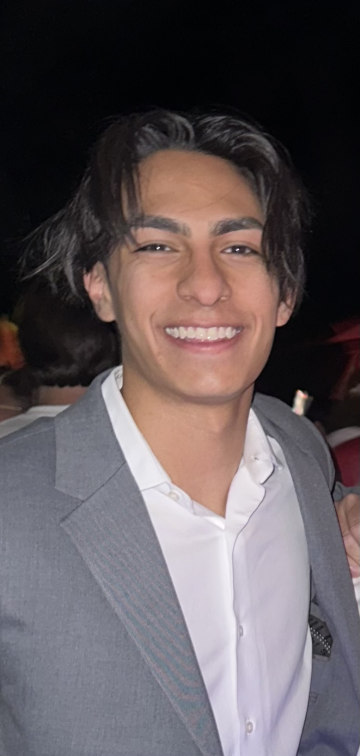 A headshot of a person smiling.