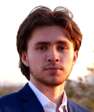 A headshot of a person with a serious face.