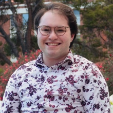 A professional headshot of a person smiling.